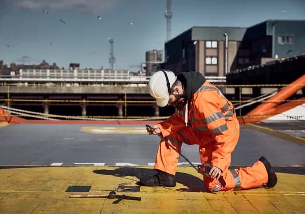 Marine surveyor carrying out an inspection on a vessel deck